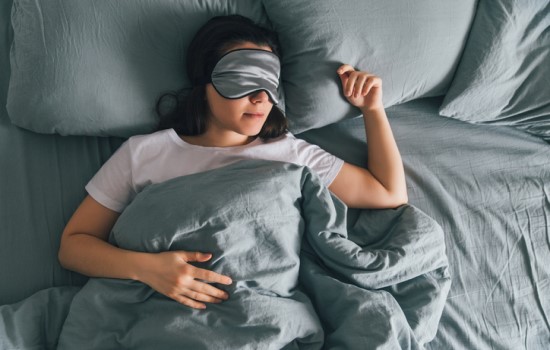 Lady sleeping with sleep mask over eyes