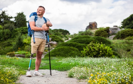 Man with prosthetic leg hiking Man with prosthetic leg hiking