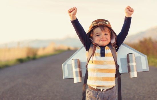 Young boy with aeroplane wings