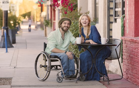 Man and woman smiling Man in wheelchair and woman smiling