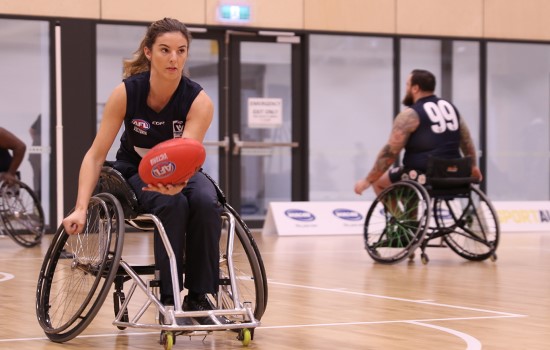 Girl playing Wheelchair Aussie Rules