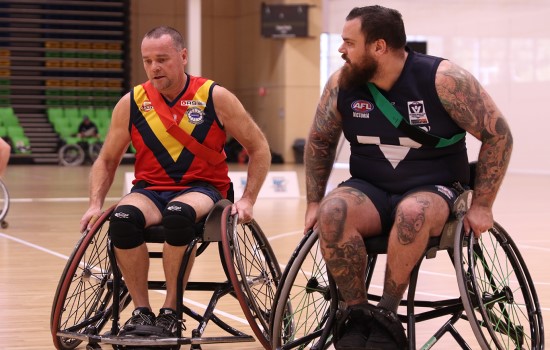 Two Men Wheelchair Aussie Rules