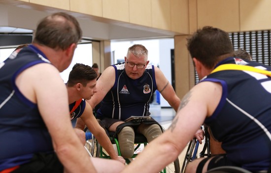 Two Men Wheelchair Aussie Rules