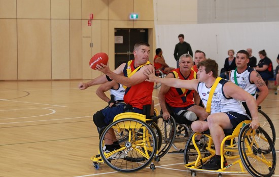 Two Men Wheelchair Aussie Rules