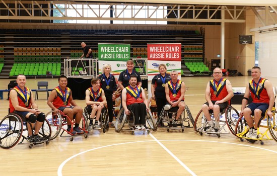 Two Men Wheelchair Aussie Rules