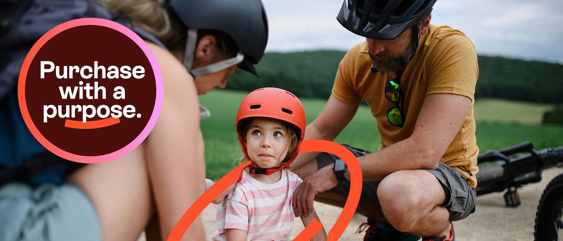 Child wearing a bike helmet with adults during an outdoor cycling activity