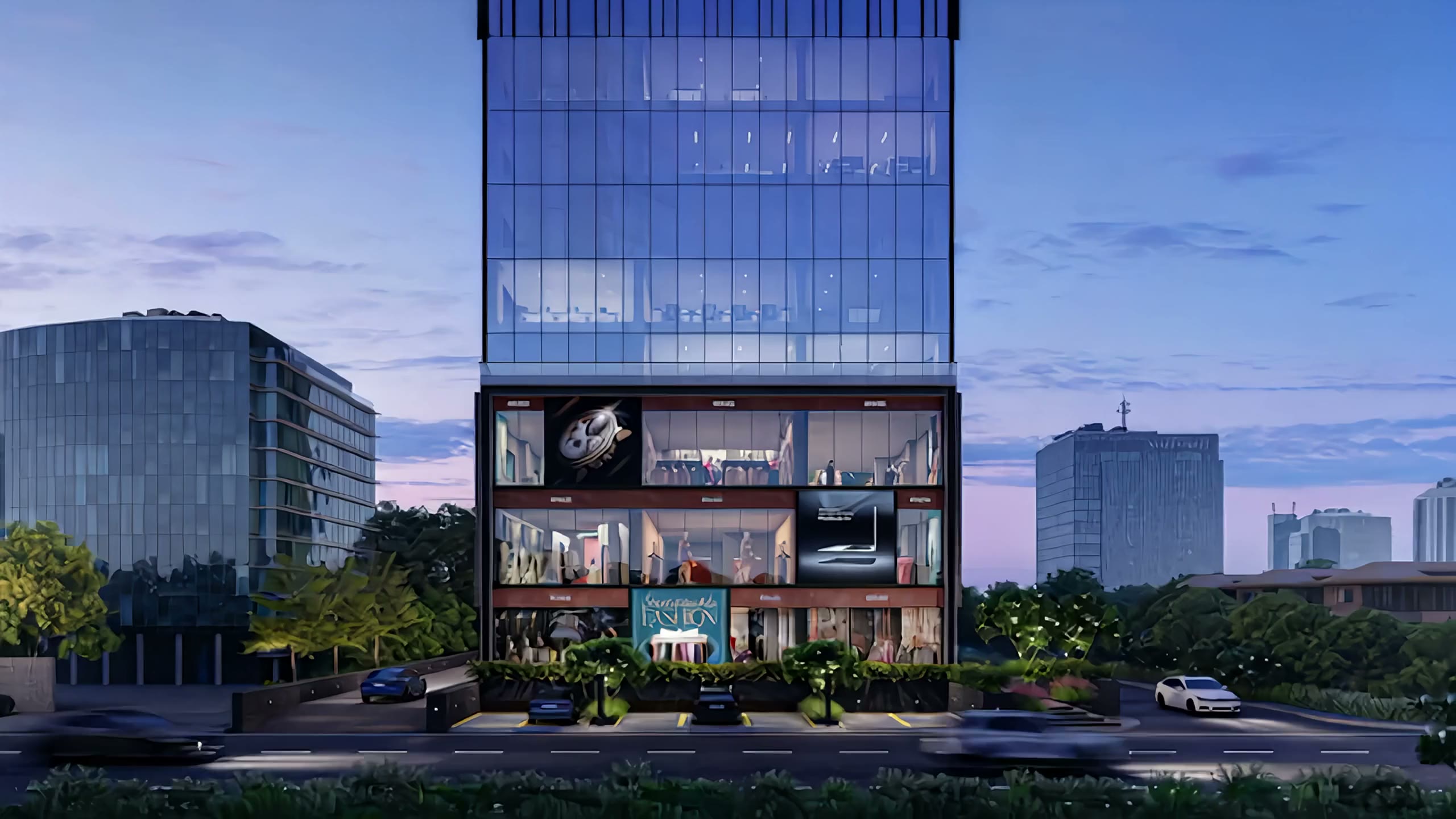 Sakar Two at dusk, a glass commercial tower above three floors of lit showrooms at the Ambli T-Junction