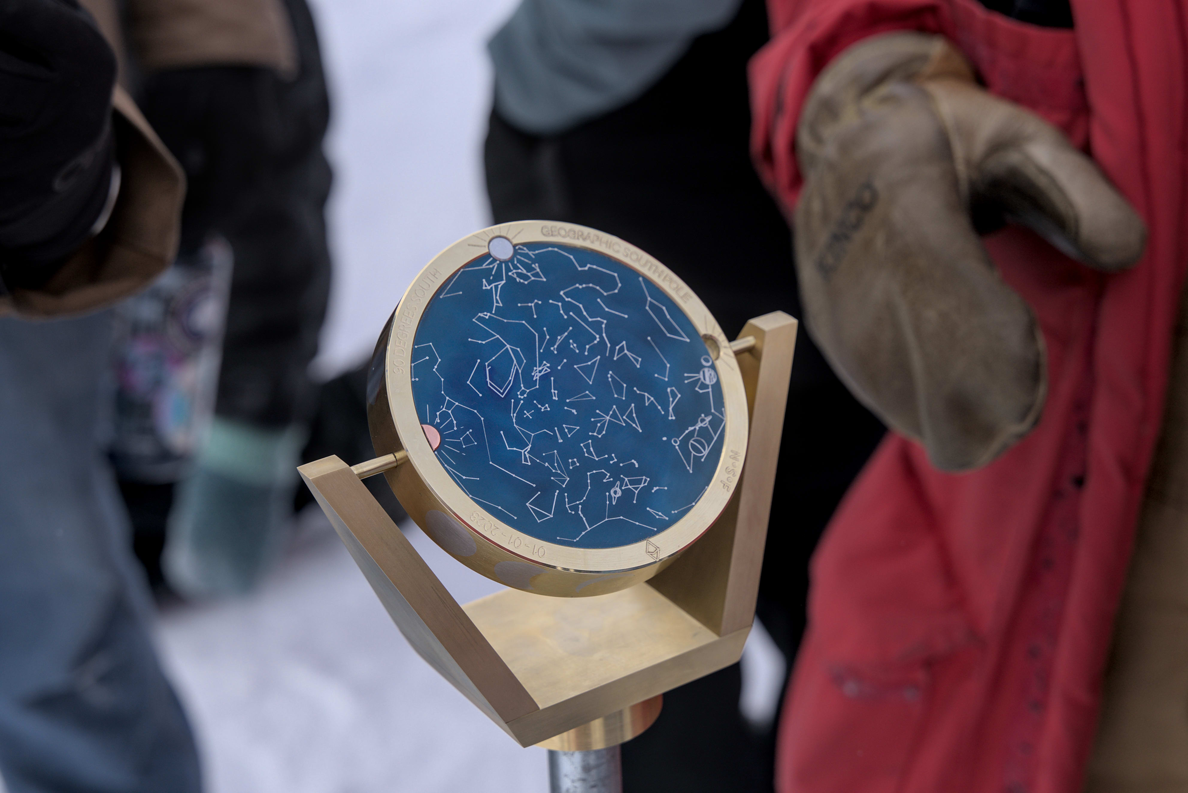 Close-up of bottom side of South Pole marker, with constellations on blue background.