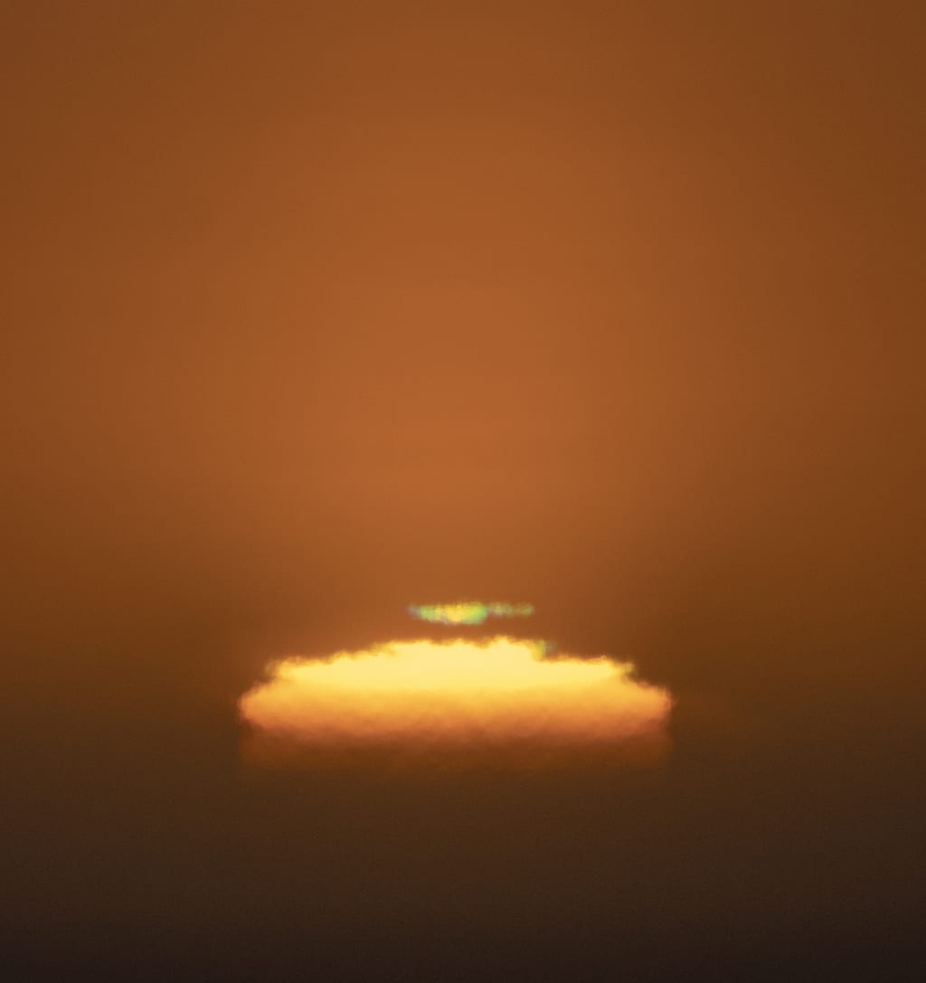 Close-up of setting sun showing the “green flash.”