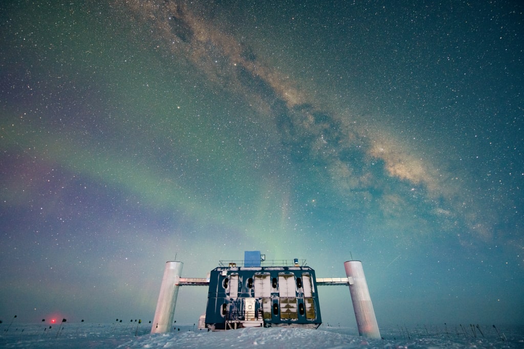 The IceCube Lab at twilight, with faint auroras and Milky Way overhead.