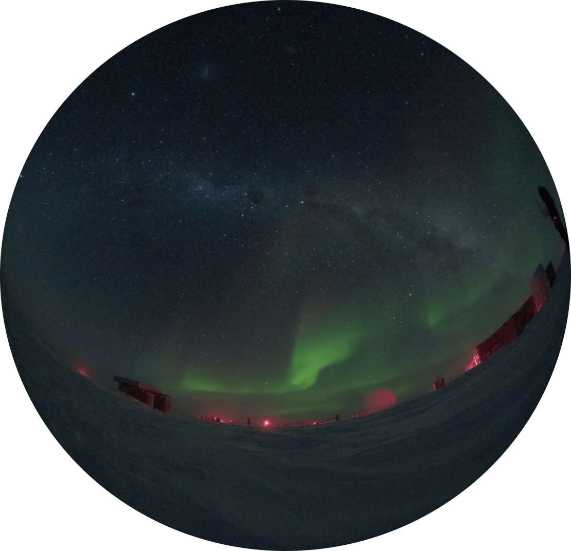 Fish-eye view of auroras above the horizon at the South Pole.