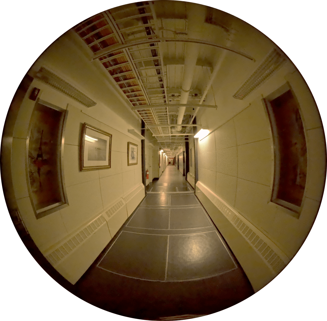 Fish-eye view of a long hallway in the lower level of the South Pole station.