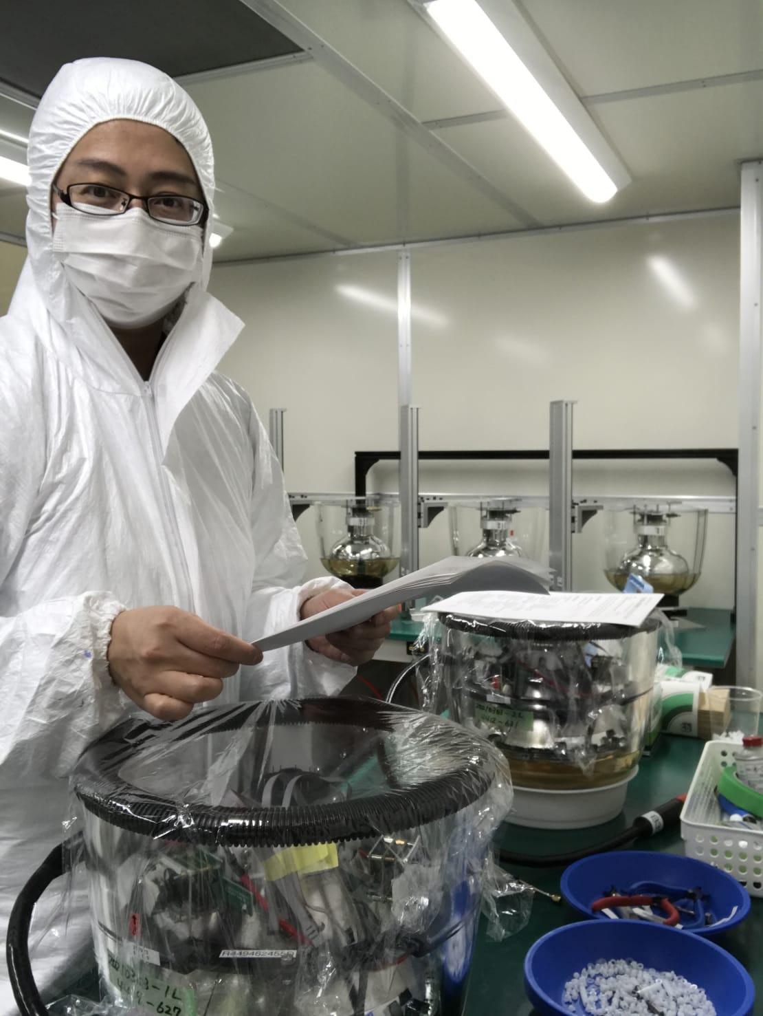 A scientist wearing protective gear with a D-Egg in early stages of production