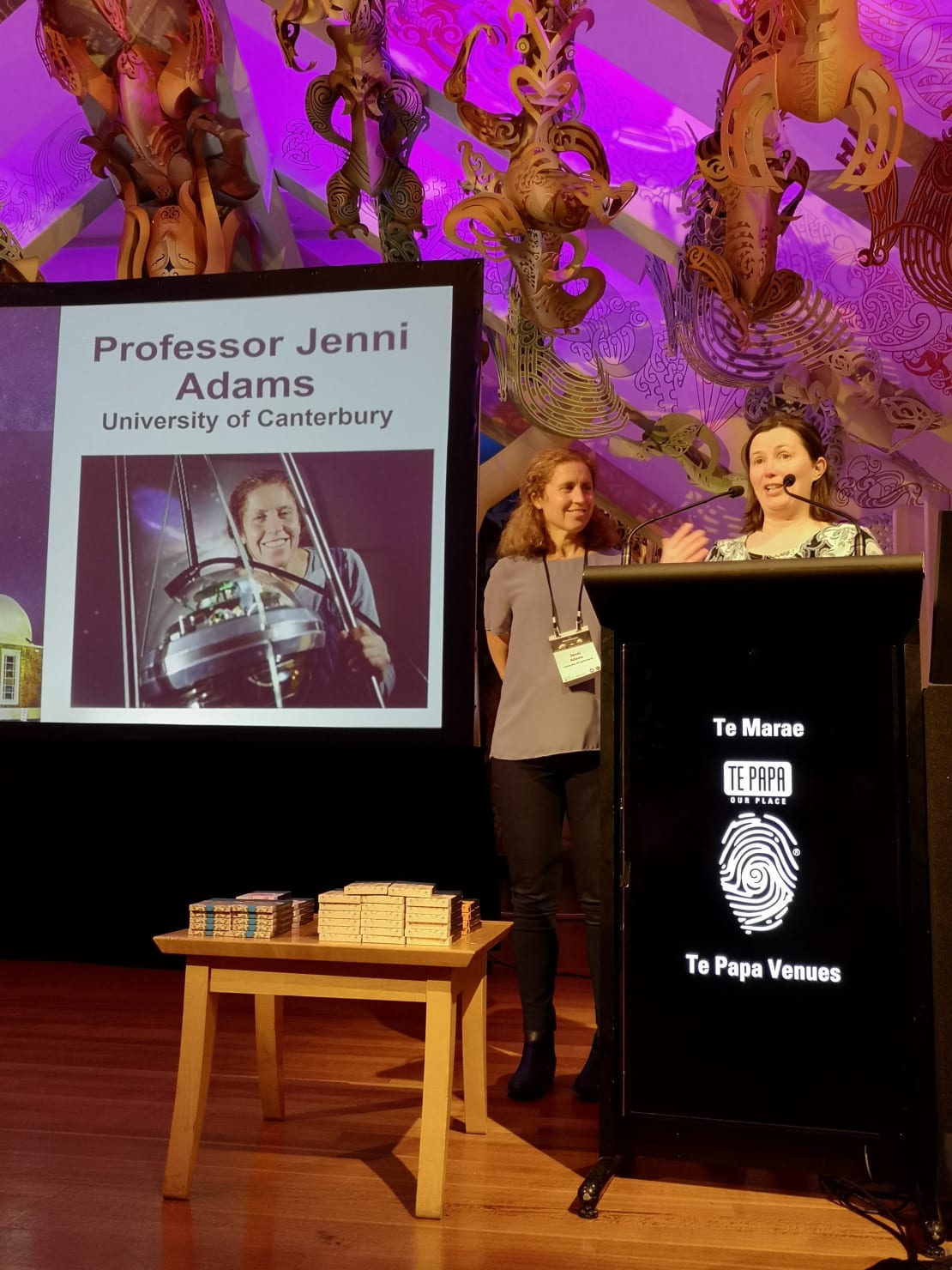 New Zealand Institute of Physics Dr Natalie Plank presents University of Canterbury Physics Professor Jenni Adams (left) with the 2021 Dan Walls medal at a ceremony in Wellington.