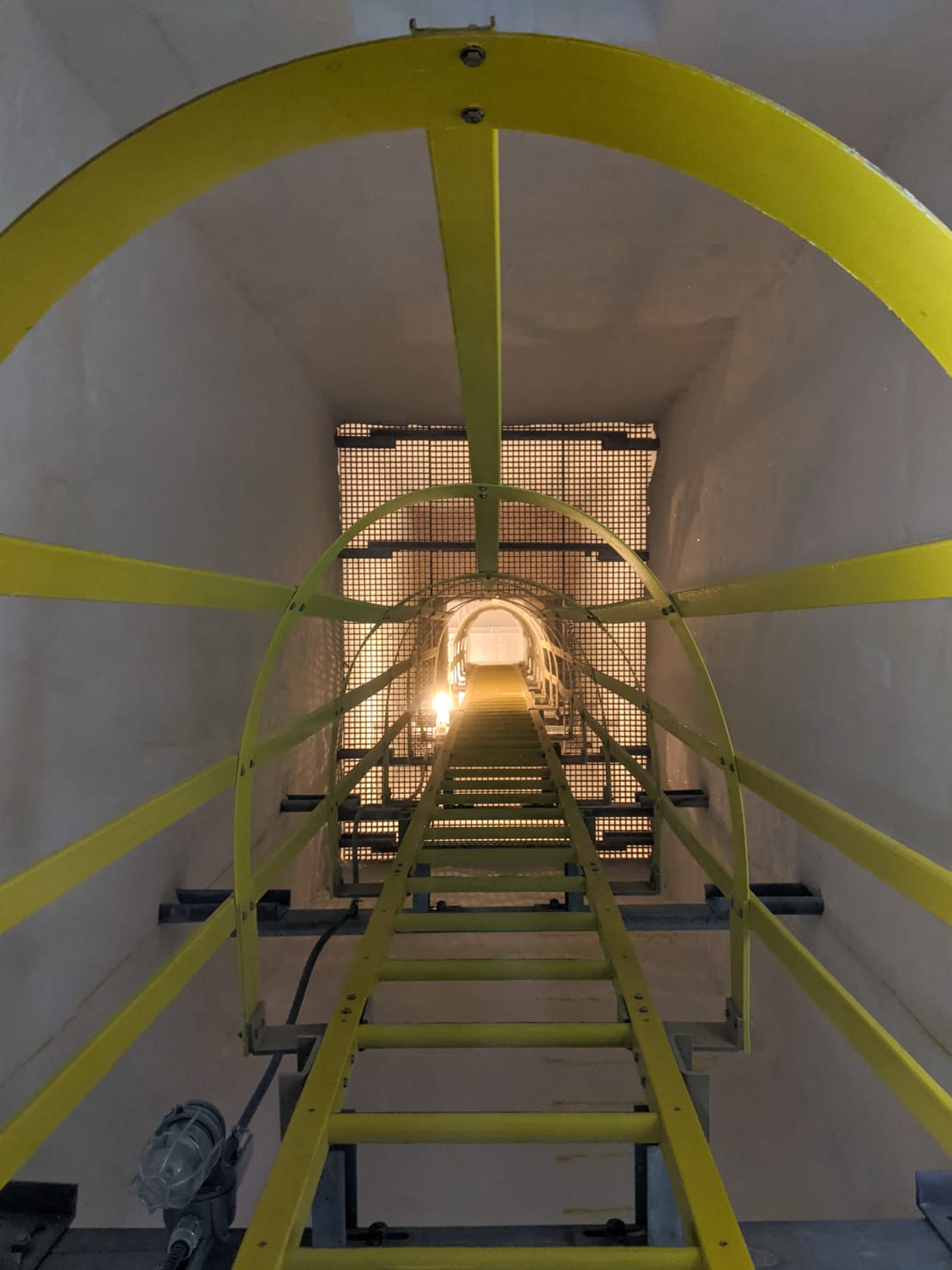 View up the staircase of an escape hatch from the ice tunnels below the South Pole station.