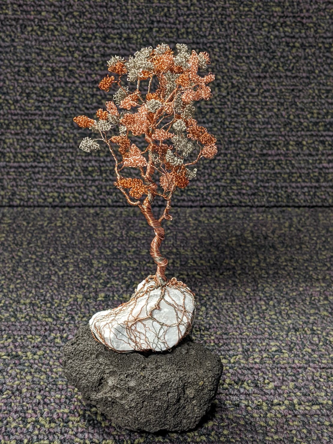 A tiny multicolored tree made with wire