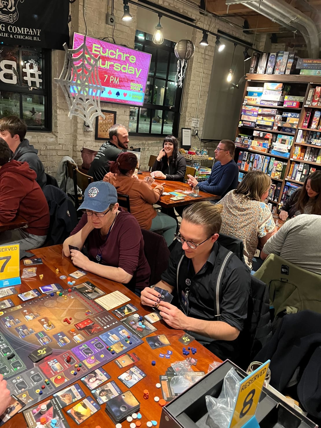 Some people playing board games at a board game lounge