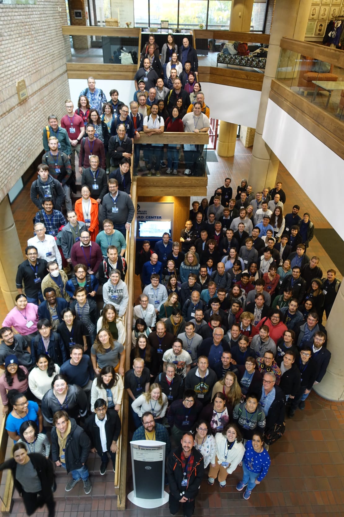 A photo of a group of people on a stairwell inside a building