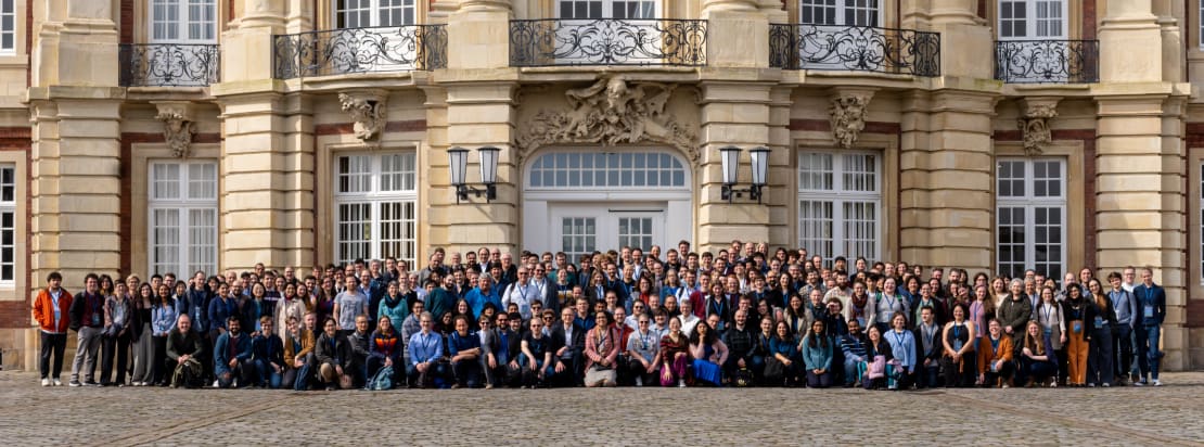 A group of people in front of a building