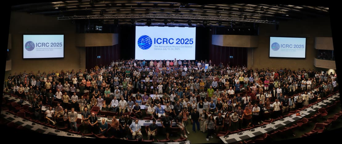 A large group of people posing in an auditorium