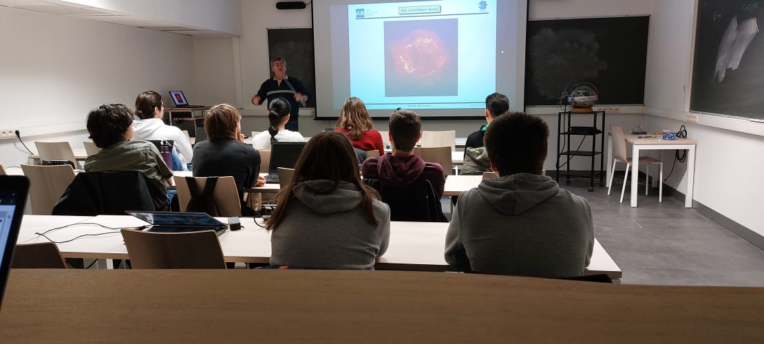 A group of students sitting down in a classroom