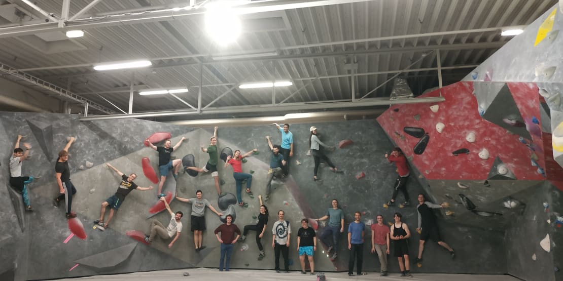 A group of people rock climbing at a gym