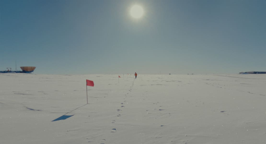 A person walking along the flag line at the South Pole