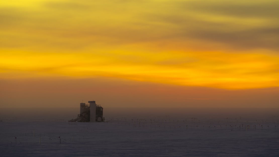 The IceCube lab at sunset, with orange cloud-filled sky.