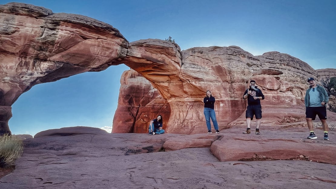 A line of people standing on rocks at Arches National Park in Utah