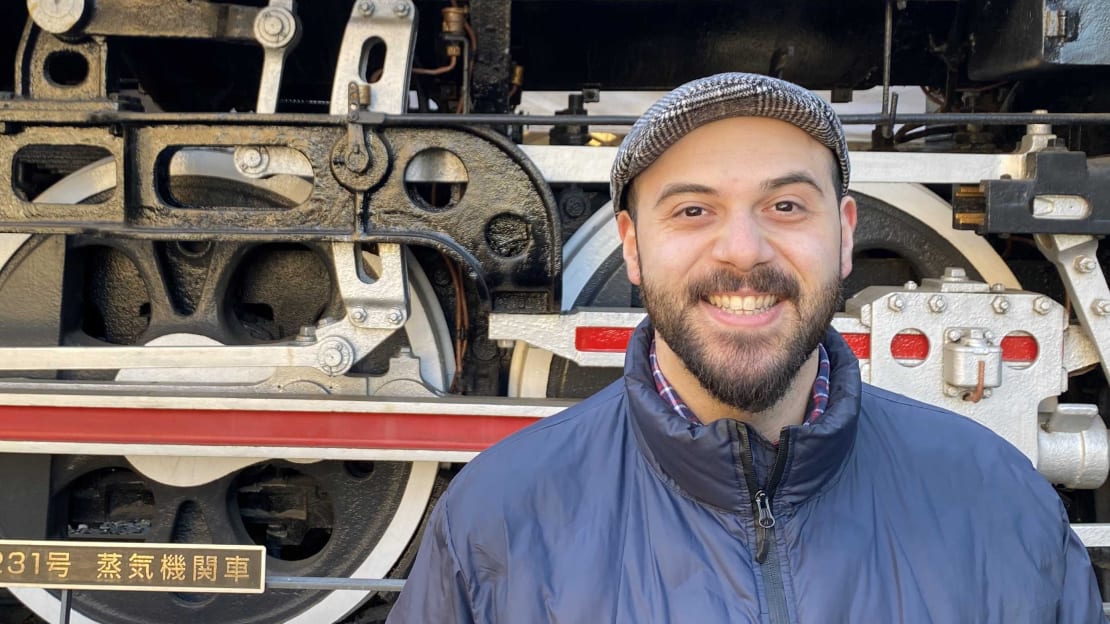 Kareem Farrag in front of a train.