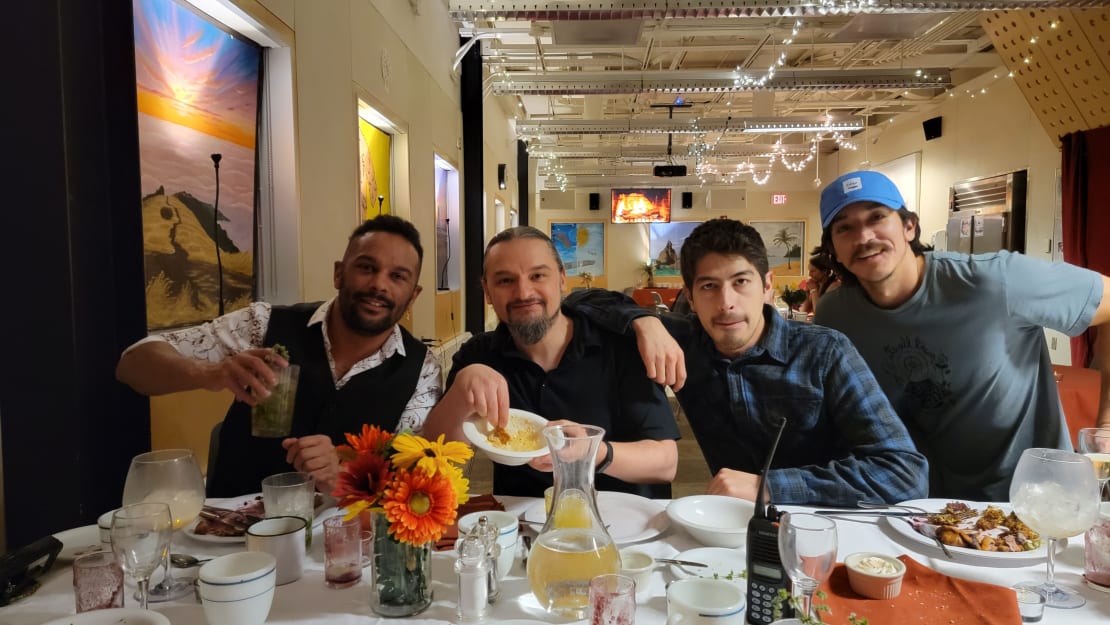 Group photo of four winterovers seated next to each other at table post meal.