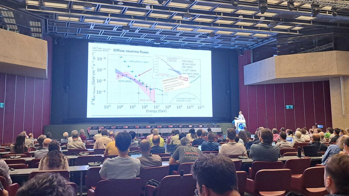 A person giving a talk on stage in an auditorium