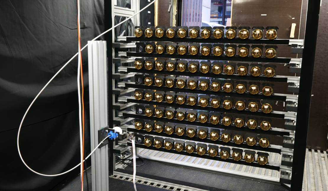 PMT testing facility at RWTH Aachen University. Shown here are 92 mDOM PMTs mounted on a custom rack in front of an illumination sphere.