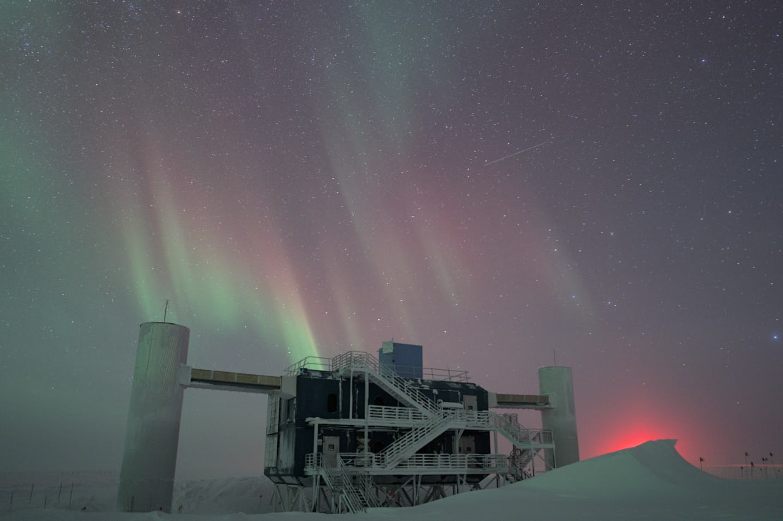 The IceCube Lab under some colorful auroras.