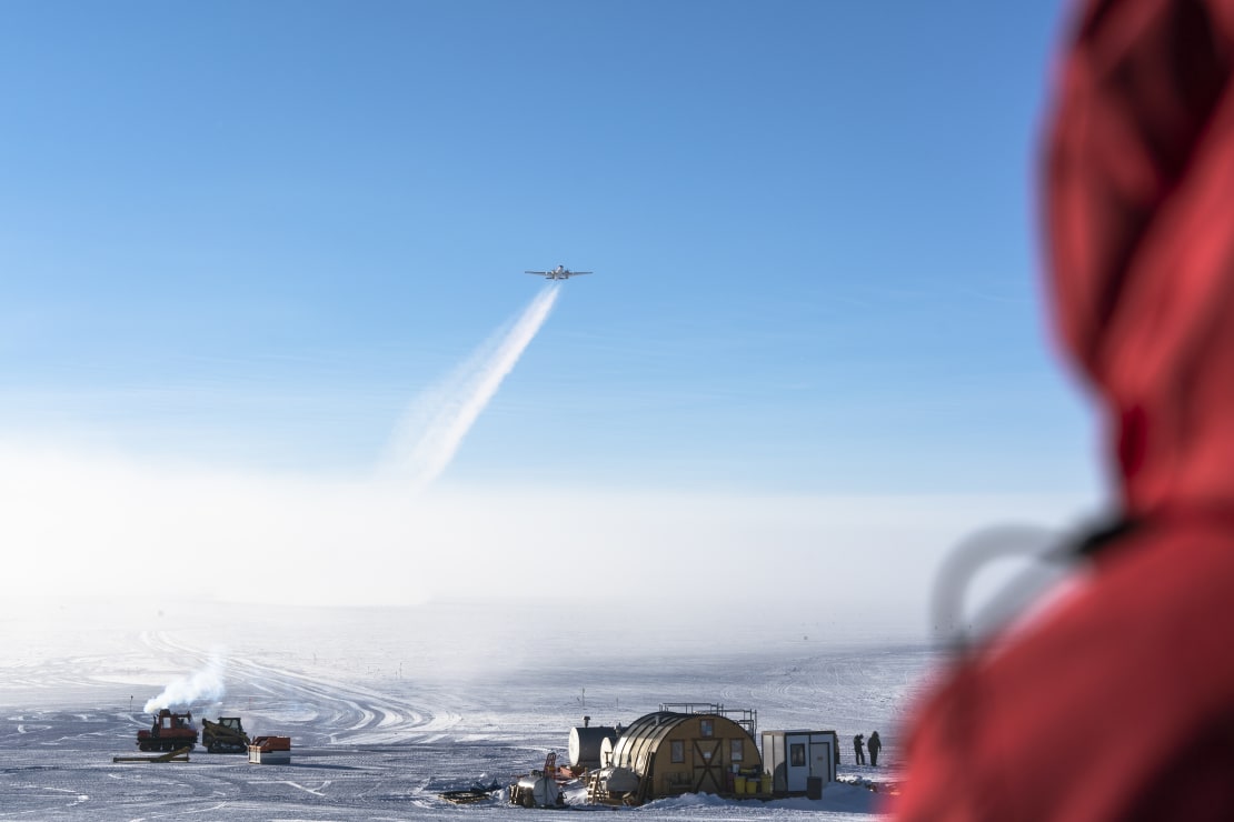 View of departing plane at take-off from observation deck on top of station.