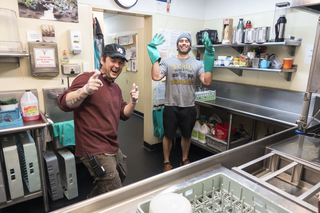 Two dish pit crew members, smiling for the camera.