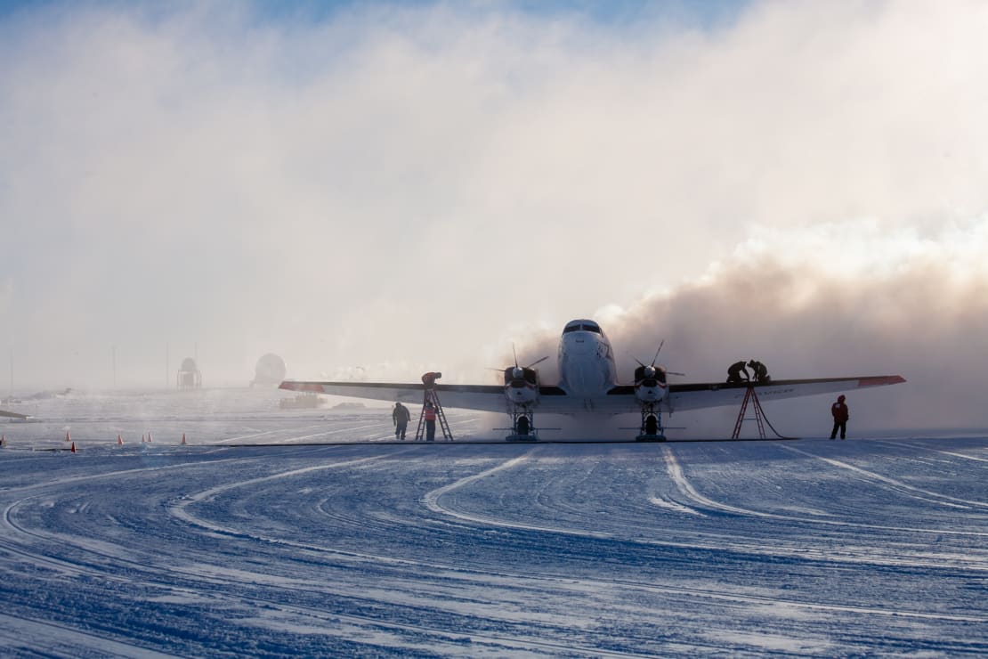 Lots of water vapor surrounding propellor plane at the South Pole during refueling.