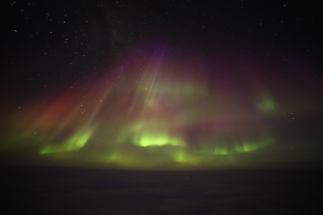 Dark sky full of green auroras.