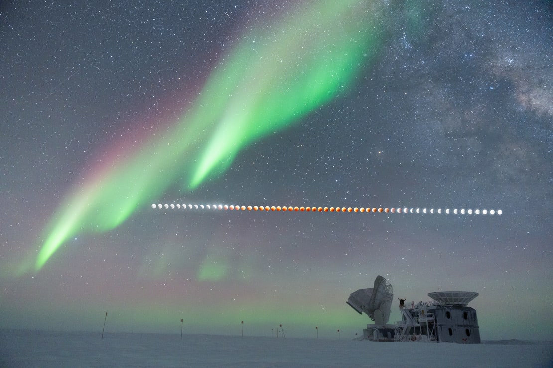 Composite shot of total lunar eclipse over the South Pole Telescope with auroras overhead.