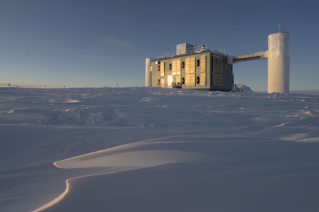 Three-quarter view facing the IceCube Lab in early sunrise.