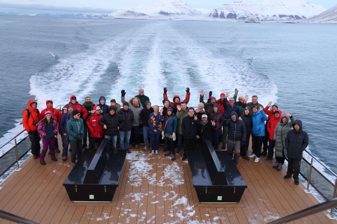 A group of people posing for a picture on a boat