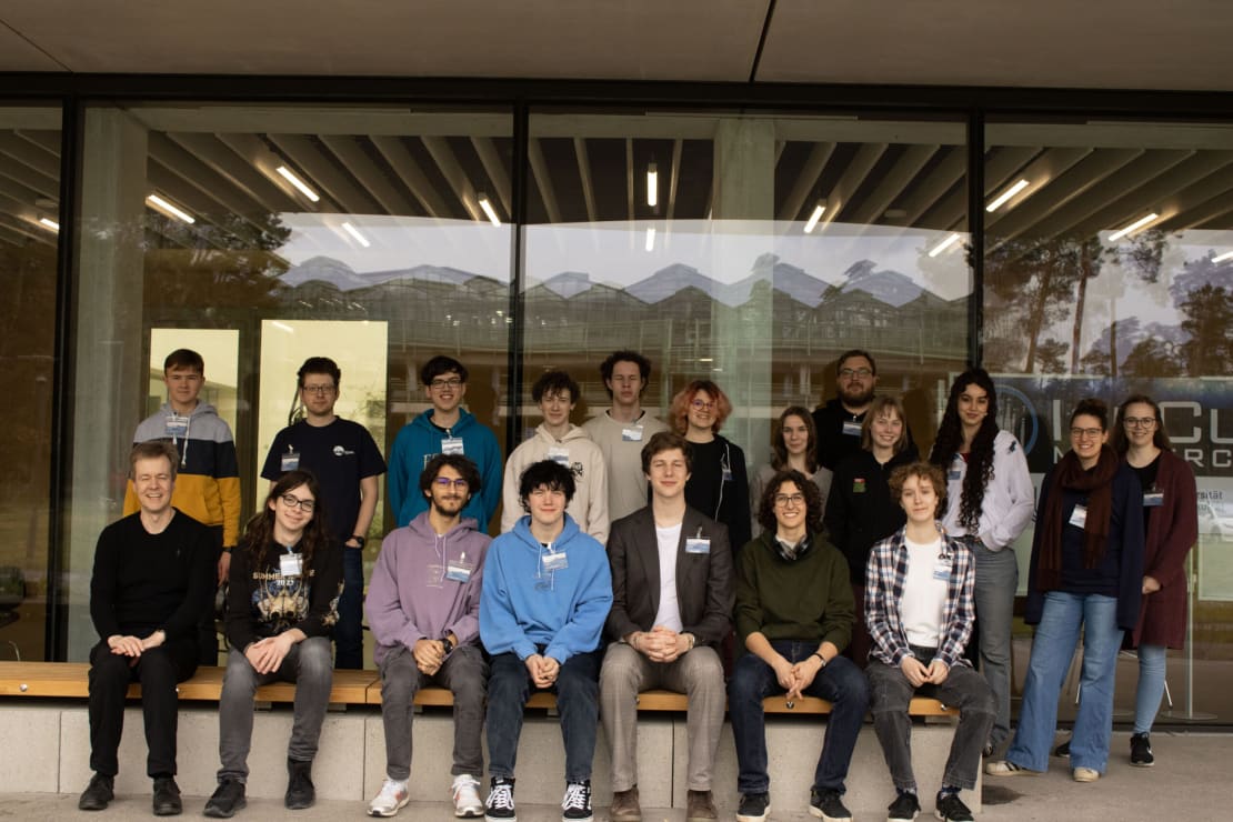 A group of people posing in front of a building