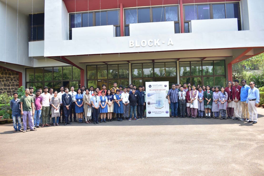A group of people posing in front of a building