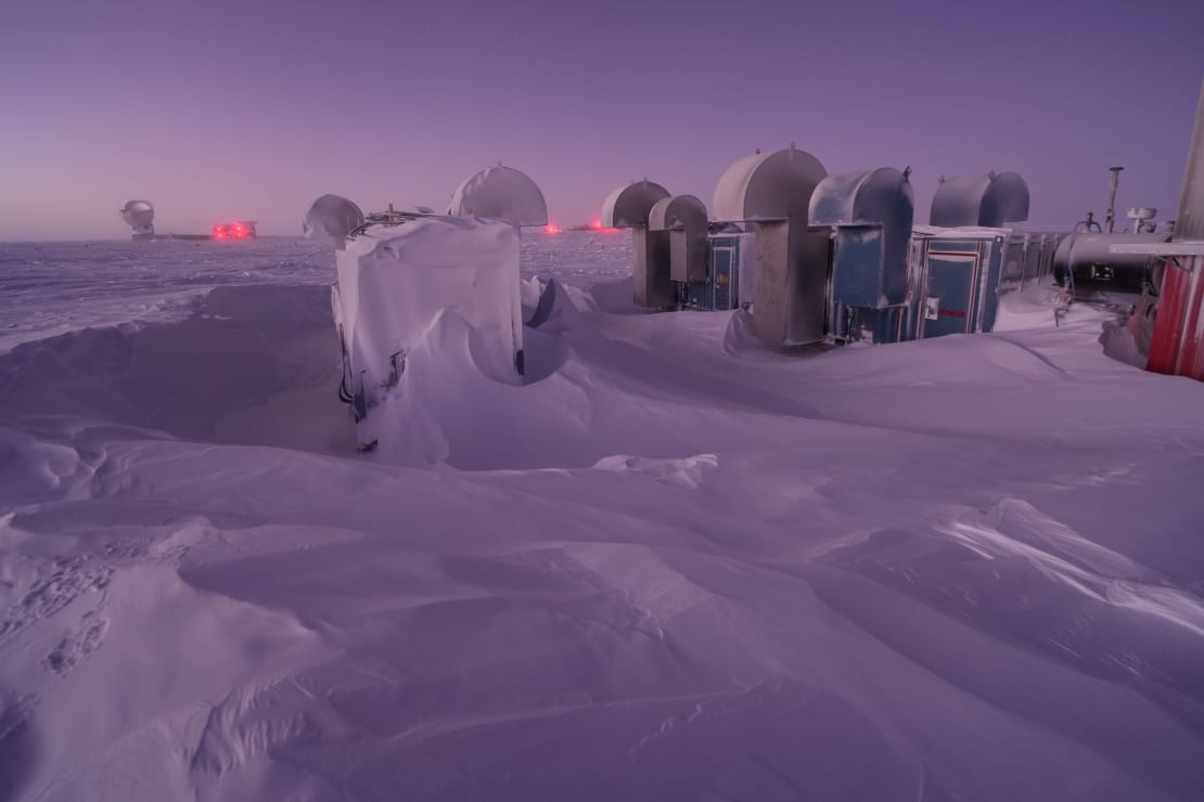 IceCube Upgrade drill camp at South Pole, frosted over structures with snow drifts.