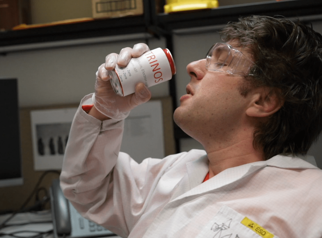 Close-up of person about the drink from can that partially shows NEUTRINOS on the label.