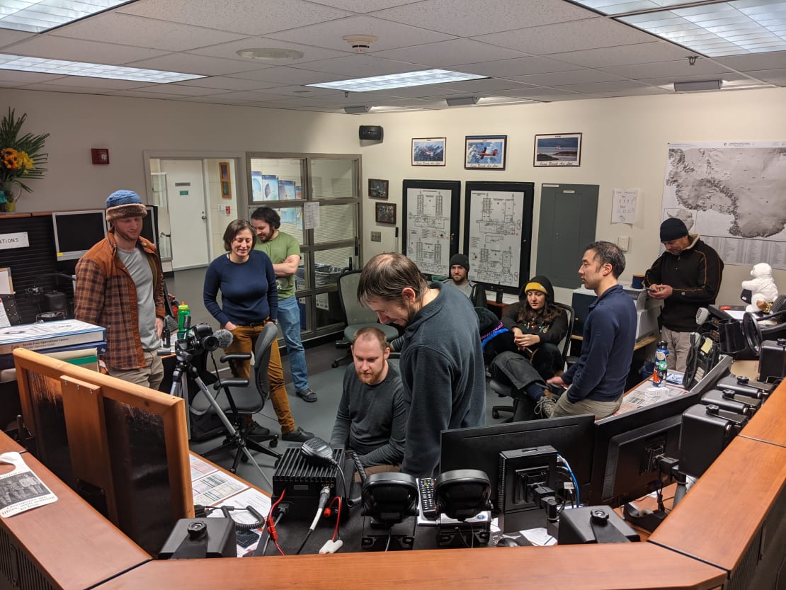 Group gathered in communications room.