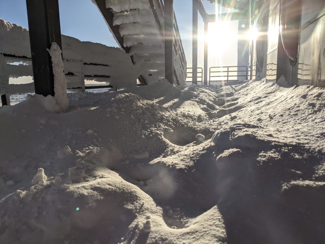 Platform and stairs outside the IceCube Lab before being cleared of snow accumulation.