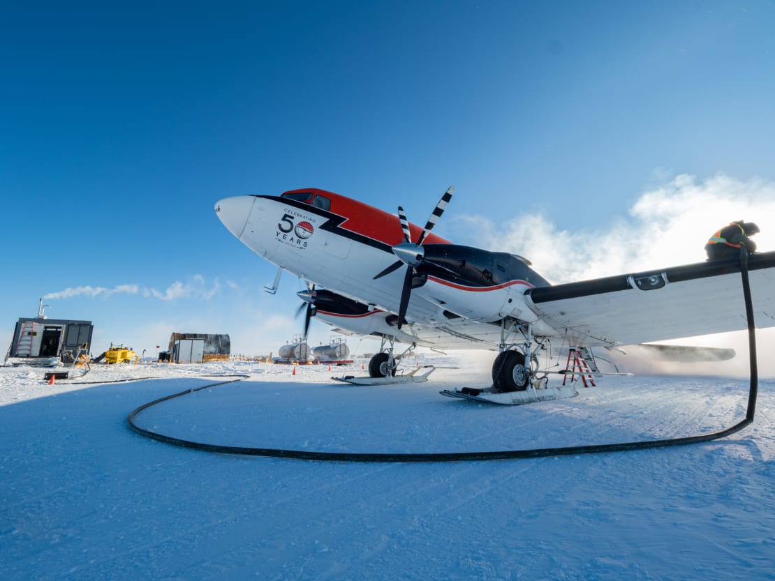 Propellor plane getting refueled.