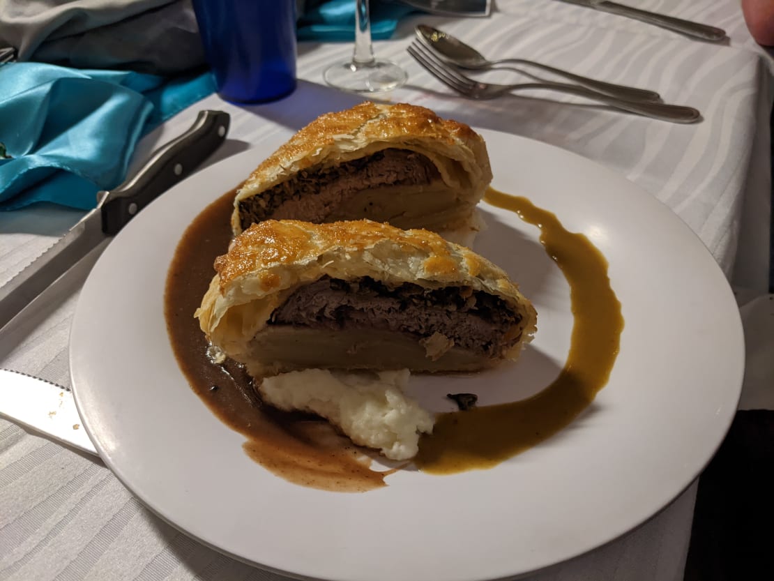 Close-up on plated slices of beef Wellington.