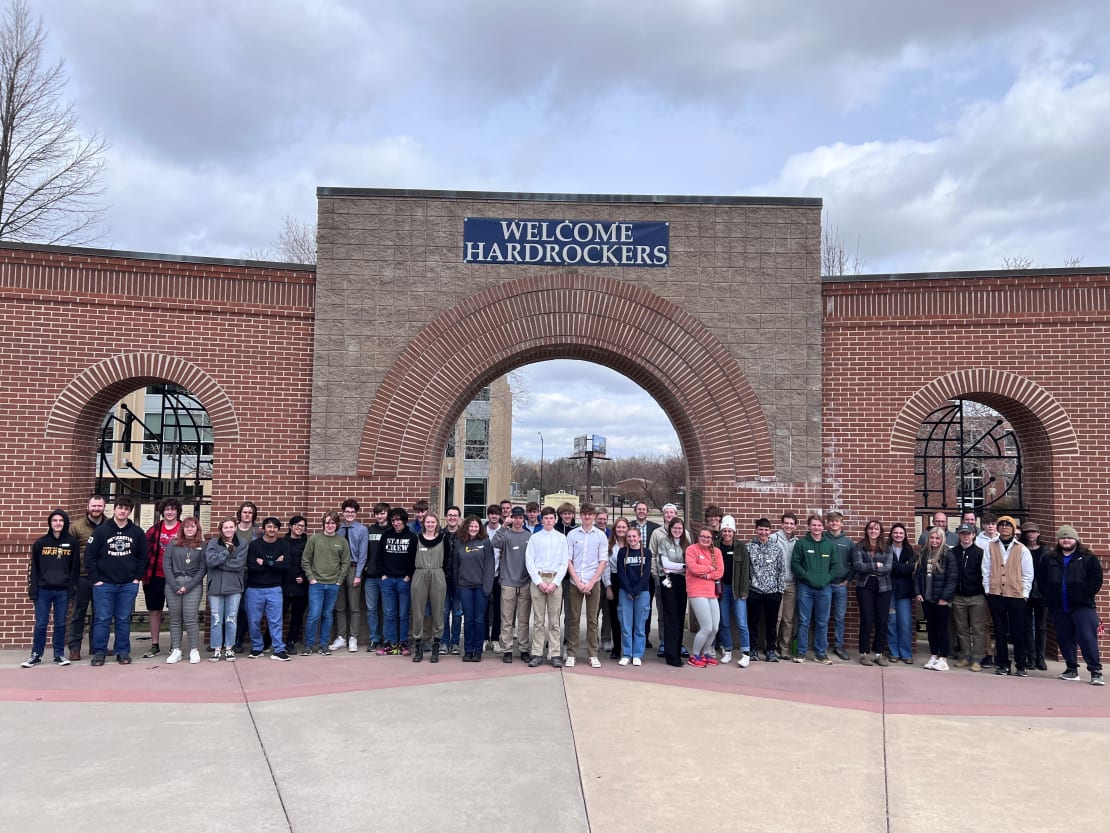 A group of students posing for a group photo outside